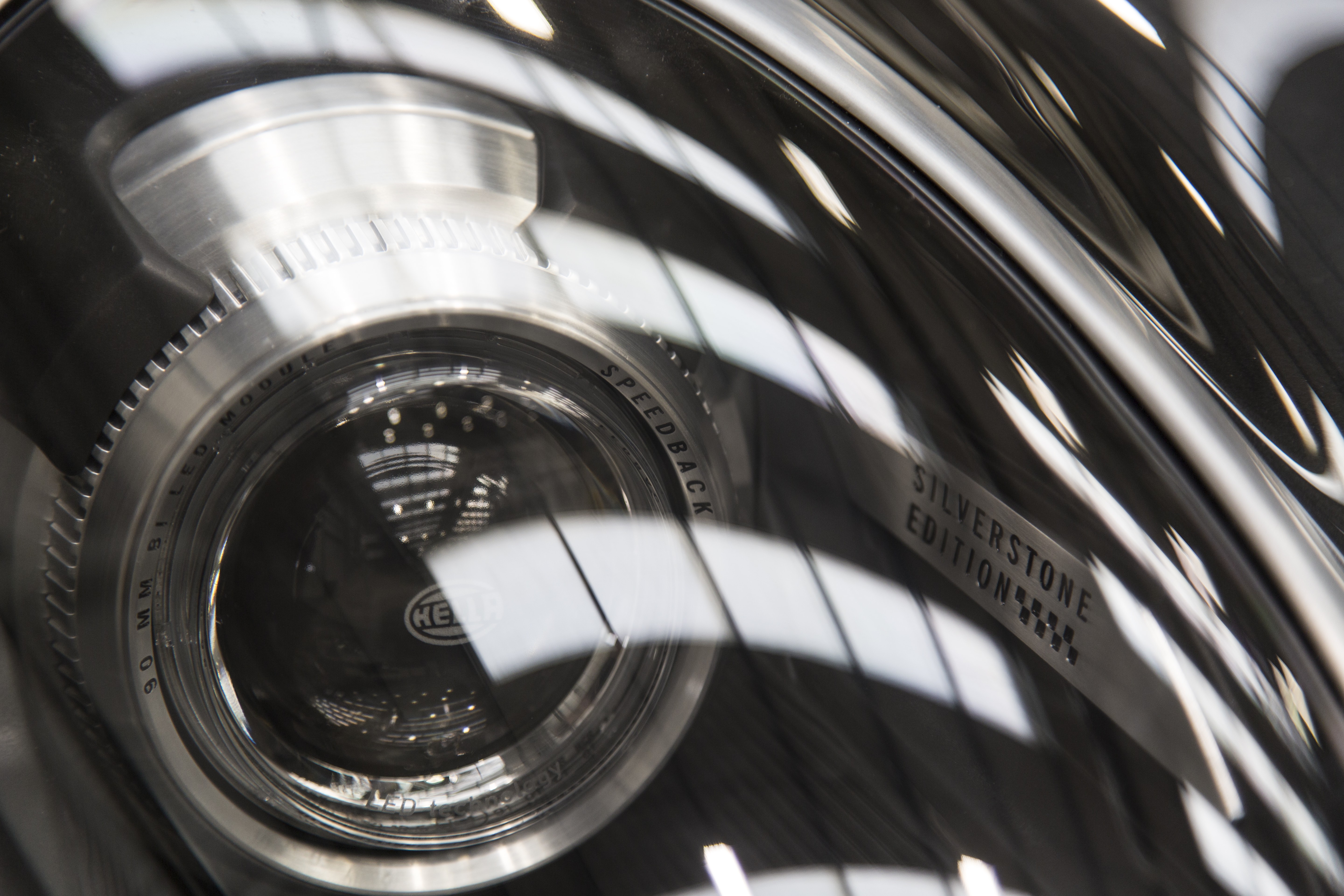 Speedback Silverstone Edition - Technical lens details and unique graphics in the dark ceramic headlamps of Speedback Silverstone Edition