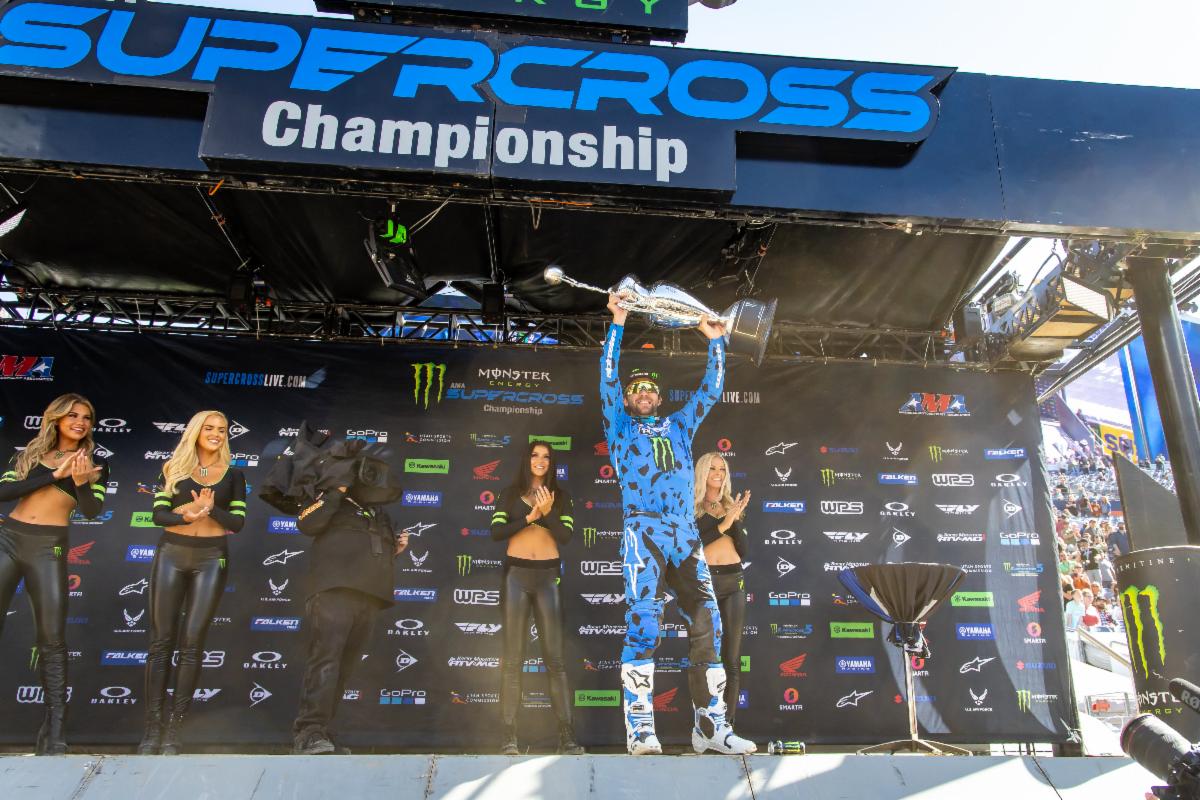 Eli Tomac hoisting the Monster Energy AMA Supercross Championship trophy