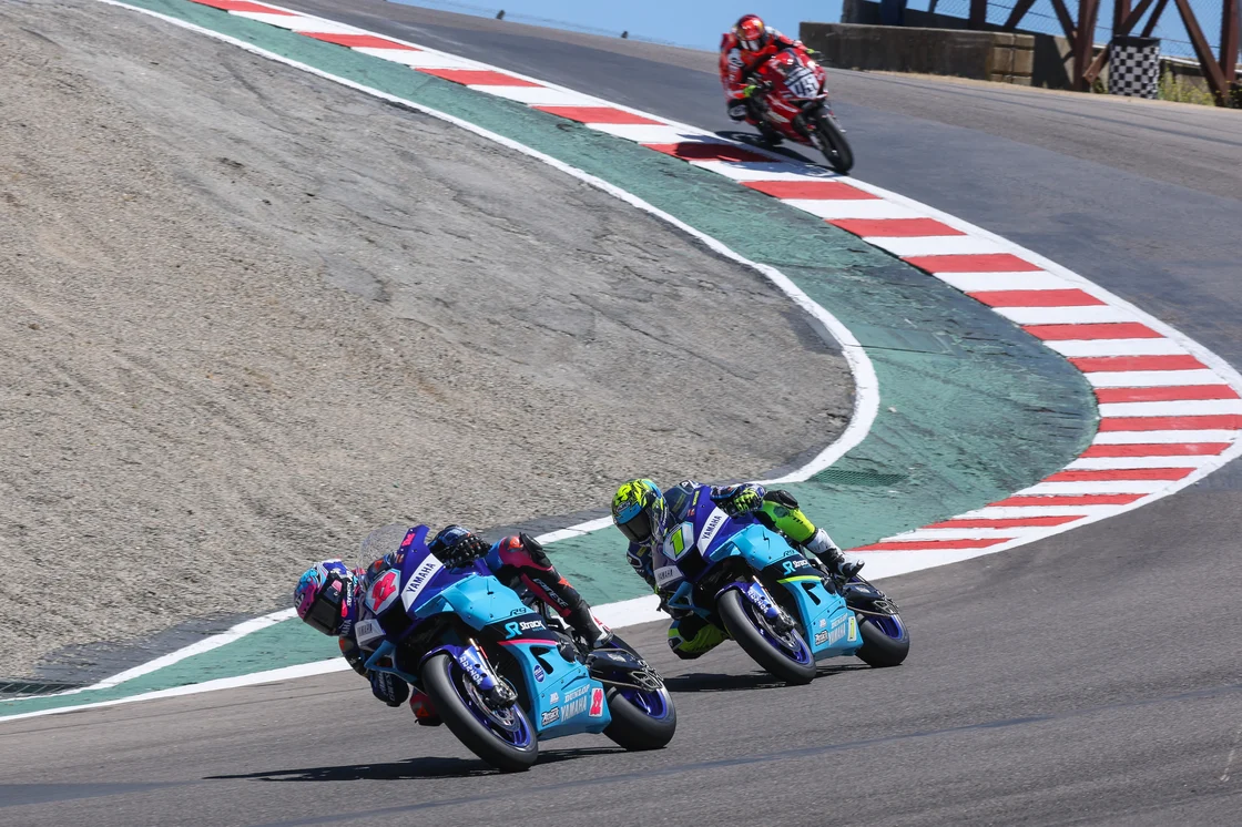 Blake Davis (22) leads teammate Mathew Scholtz (1) and a fast-closing Cameron Petersen (46) through the Corkscrew in Sunday's Motovation Supersport race